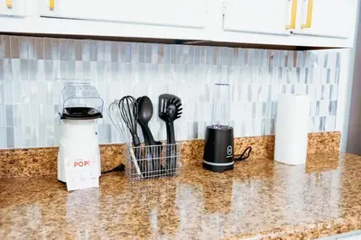 a kitchen counter with utensils on a counter top at Fast transit to Manhattan with Parking on premises in North Bergen