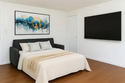 a bedroom with a bed and a flat screen tv at Fast transit to Manhattan with Parking on premises in North Bergen