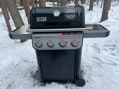 a stove top oven sitting in the snow at Evergreen Escapes 4 BR with Game Room, Firepit near Kalahari and Camelback in Long Pond