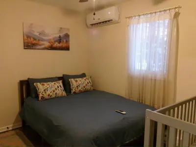 a bedroom with a bed and a window at Evergreen Escapes 4 BR with Game Room, Firepit near Kalahari and Camelback in Long Pond