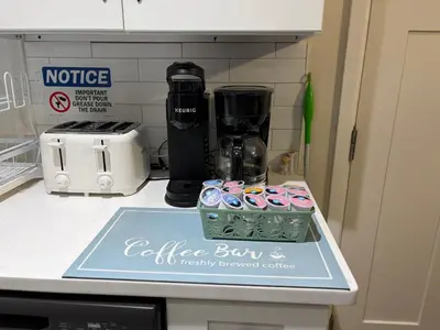 a counter top with a coffee maker and a tray of cupcakes at Evergreen Escapes 4 BR with Game Room, Firepit near Kalahari and Camelback in Long Pond