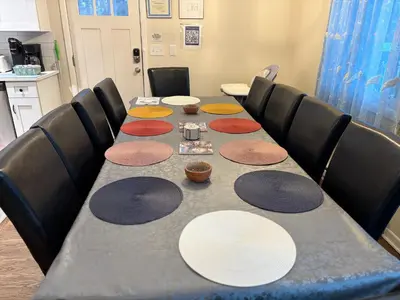 a long table with white plates on top of it at Evergreen Escapes 4 BR with Game Room, Firepit near Kalahari and Camelback in Long Pond