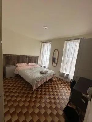 a bedroom with a bed and a tiled floor at Al Demashqi in New York