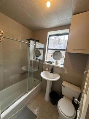 a bathroom with a toilet and a sink and a shower at Al Demashqi in New York
