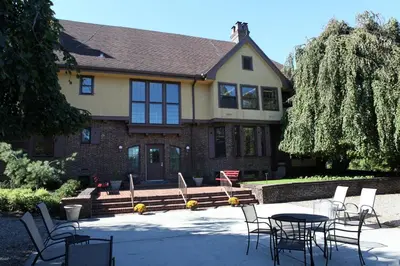 a table and chairs in front of a house at Rutgers University Inn and Conference Center in New Brunswick