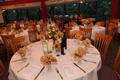 a table set up for a wedding with flowers and wine bottles at Rutgers University Inn and Conference Center in New Brunswick