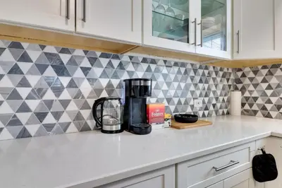 a kitchen counter with a coffee maker on a counter top at The Vault Your Fun Secured in Hillside