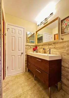 a bathroom with a sink and a mirror at Cozy Riverside View House in Montague