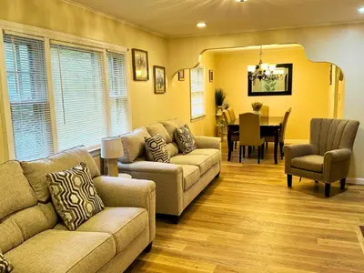 a living room with a couch and a dining room at Cozy Riverside View House in Montague