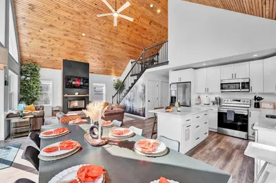 a large kitchen with a table with food on it at Chalet with Hot Tub, Game, Movie Room, Lake and Pool Access in Gouldsboro