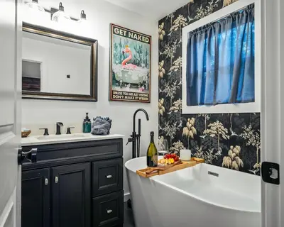 a bathroom with a tub and a sink and a bath tub at Chalet with Hot Tub, Game, Movie Room, Lake and Pool Access in Gouldsboro