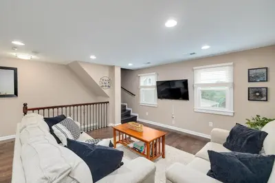 a living room with a couch and a tv at Cozy Full Home with Parking, 10min Walk to Bridge St in Phoenixville