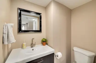 a bathroom with a white sink and a mirror at Cozy Full Home with Parking, 10min Walk to Bridge St in Phoenixville