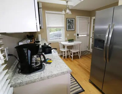 a kitchen with a stainless steel refrigerator and a table at Private Oasis Ranch • In Town Princeton • 2BR/2B in Princeton