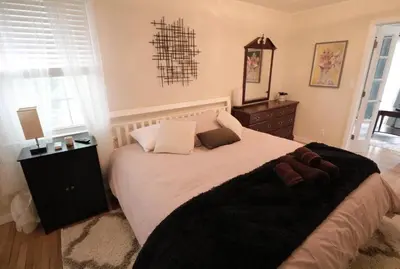 a bedroom with a large bed with a black blanket at Private Oasis Ranch • In Town Princeton • 2BR/2B in Princeton