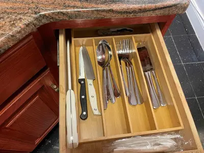 a wooden drawer with utensils in a kitchen at Private Studio Apartment in Union Square in New York