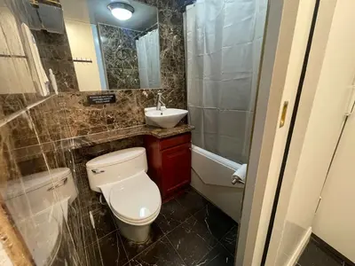 a small bathroom with a toilet and a sink at Private Studio Apartment in Union Square in New York