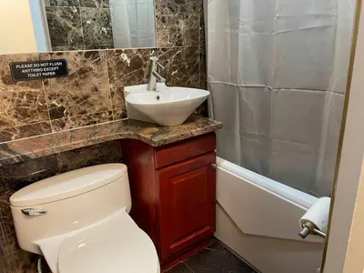 a bathroom with a toilet and a sink and a tub at Private Studio Apartment in Union Square in New York