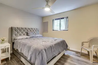 a bedroom with a large bed and a window at Poconos Family Home with Game Room and Community Perks in East Stroudsburg