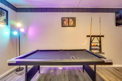 a ping pong table in a room with a pool table at Poconos Family Home with Game Room and Community Perks in East Stroudsburg