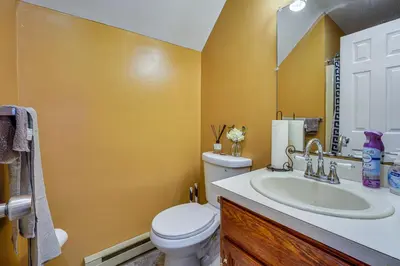 a bathroom with a white toilet and a sink at Poconos Family Home with Game Room and Community Perks in East Stroudsburg