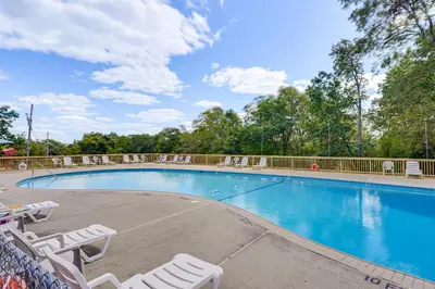 a large swimming pool with lounge chairs at Poconos Family Home with Game Room and Community Perks in East Stroudsburg