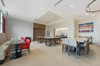a dining room with tables and red chairs at Hilton Garden Inn Media in Media