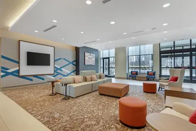 a lobby with couches and a flat screen tv at Hilton Garden Inn Media in Media