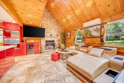 a living room with a couch and a tv at Stunning! Pocono Escape! HotTub Sauna Pool Ski Pet-Friendly Firepit Game Room Fireplace BBQ Lakes Tennis Fishing in Long Pond