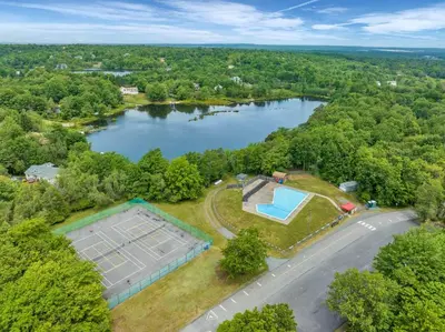 an aerial view of a lake with a tennis court at Stunning! Pocono Escape! HotTub Sauna Pool Ski Pet-Friendly Firepit Game Room Fireplace BBQ Lakes Tennis Fishing in Long Pond