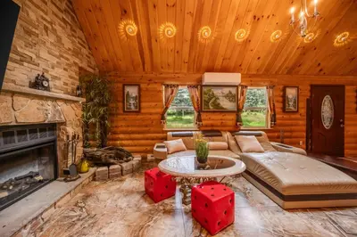 a living room with a couch and a fireplace at Stunning! Pocono Escape! HotTub Sauna Pool Ski Pet-Friendly Firepit Game Room Fireplace BBQ Lakes Tennis Fishing in Long Pond