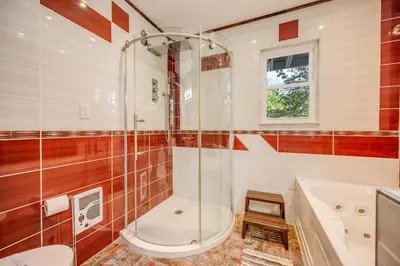 a bathroom with a shower and a tub and a sink at Stunning! Pocono Escape! HotTub Sauna Pool Ski Pet-Friendly Firepit Game Room Fireplace BBQ Lakes Tennis Fishing in Long Pond