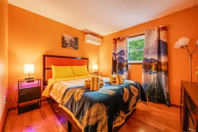 a bedroom with a bed and a window at Stunning! Pocono Escape! HotTub Sauna Pool Ski Pet-Friendly Firepit Game Room Fireplace BBQ Lakes Tennis Fishing in Long Pond