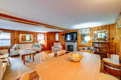 a living room with a wooden table and a couch at 25 Mi to Elk Mtn Skiing! Susquehanna River Cabin