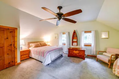 a bedroom with a bed and a ceiling fan at 25 Mi to Elk Mtn Skiing! Susquehanna River Cabin