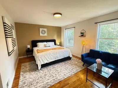 a bedroom with a bed and a blue couch at Luxury 3BR 2BA Retreat NYC Getaway Free Parking in Jersey City