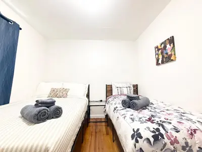 two beds sitting next to each other in a bedroom at Luxury 3BR 2BA Retreat NYC Getaway Free Parking in Jersey City