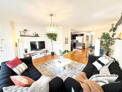 a living room with a couch and a tv at Luxury 3BR 2BA Retreat NYC Getaway Free Parking in Jersey City
