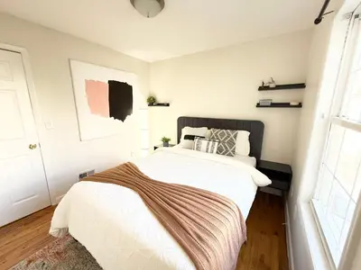 a bedroom with a bed with a blanket on it at Luxury 3BR 2BA Retreat NYC Getaway Free Parking in Jersey City