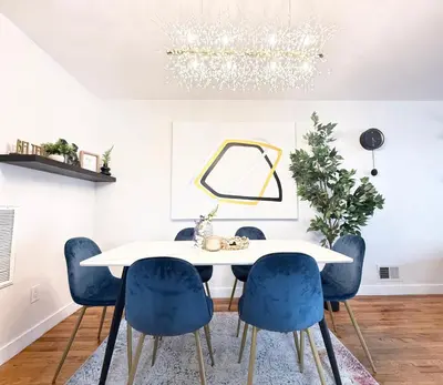 a dining room with a white table and blue chairs at Luxury 3BR 2BA Retreat NYC Getaway Free Parking in Jersey City