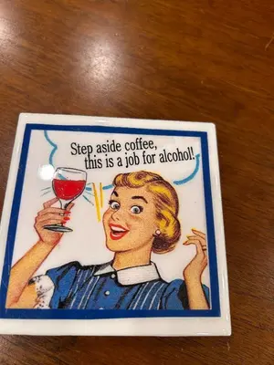 a sign with a woman holding a glass of wine at The Highland Oasis in Ephrata