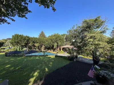 a yard with a swimming pool and an american flag at The Highland Oasis in Ephrata