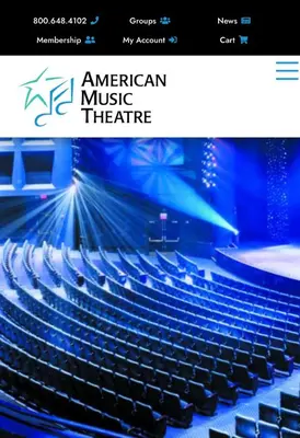 an auditorium with blue chairs and a stage at The Highland Oasis in Ephrata