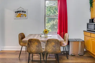 a dining room table with four chairs and a window at Walkable Location Pet-Friendly Apartment in Lodi! in Lodi
