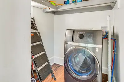 a washing machine in a laundry room with a shelf at Walkable Location Pet-Friendly Apartment in Lodi! in Lodi