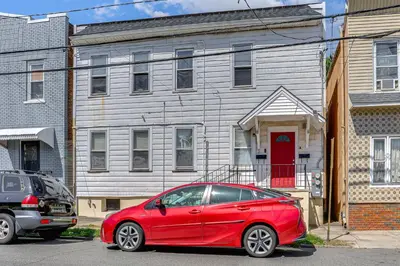 a red car parked in front of a house at Walkable Location Pet-Friendly Apartment in Lodi! in Lodi