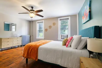 a bedroom with a bed and a ceiling fan at Spacious Broadway Home Downtown Western Modern Charm with parking in Jim Thorpe