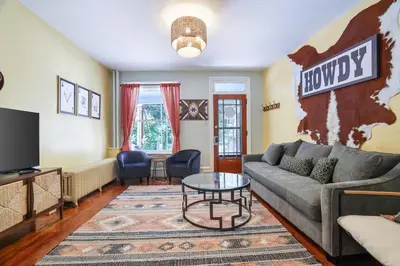 a living room with a couch and a table at Spacious Broadway Home Downtown Western Modern Charm with parking in Jim Thorpe