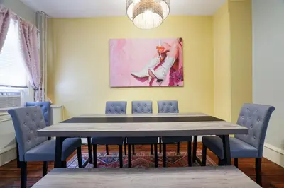a dining room table with chairs and a painting on the wall at Spacious Broadway Home Downtown Western Modern Charm with parking in Jim Thorpe