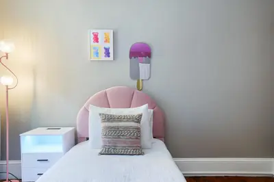 a pink bed with a pink headboard in a room at Spacious Broadway Home Downtown Western Modern Charm with parking in Jim Thorpe